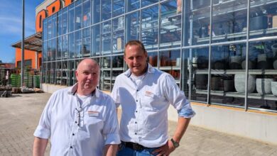 two men standing in front of a building