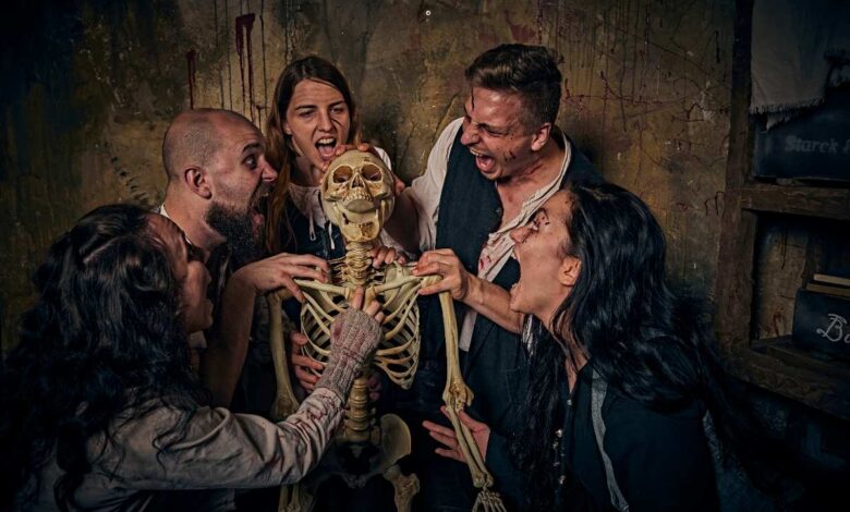a group of people holding a skeleton